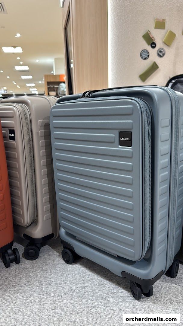 Stylish LOJEL suitcases displayed in a retail store setting.
