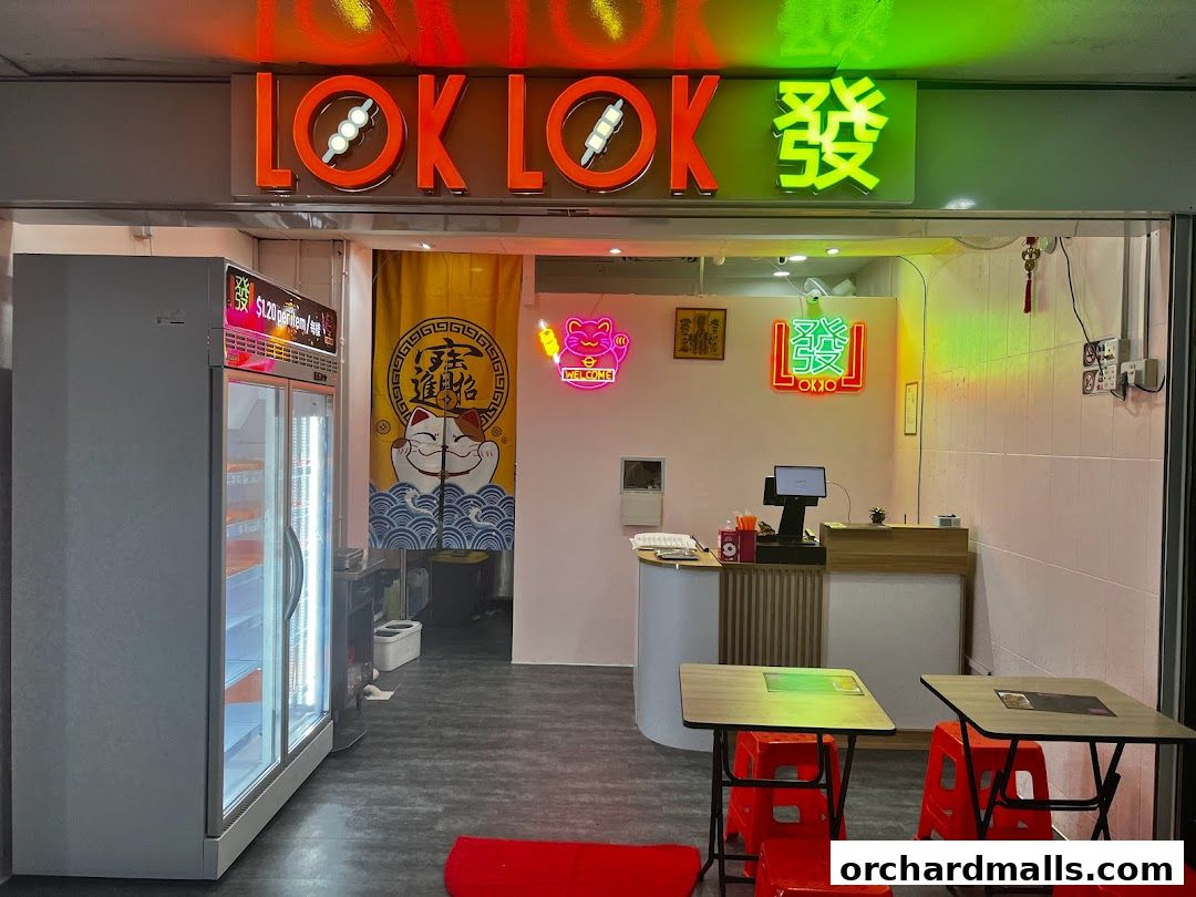 The exterior of Lok Lok Fa, a shop with bright neon signs and a display fridge.