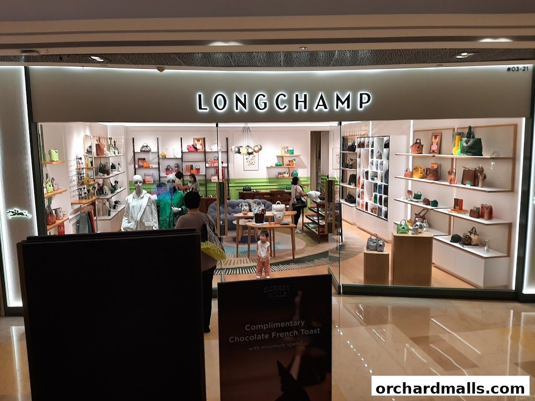 The Longchamp store features a well-lit interior showcasing a variety of handbags and accessories on display.