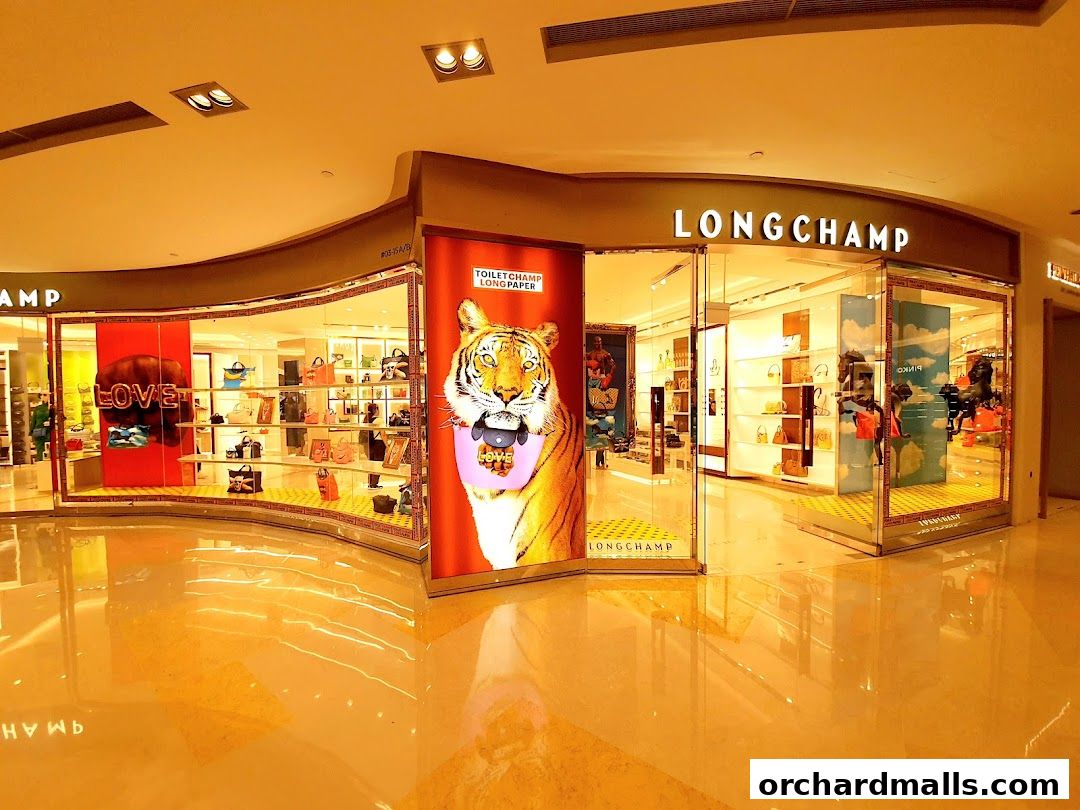 The Longchamp store features a vibrant display with a tiger graphic and various handbags showcased.