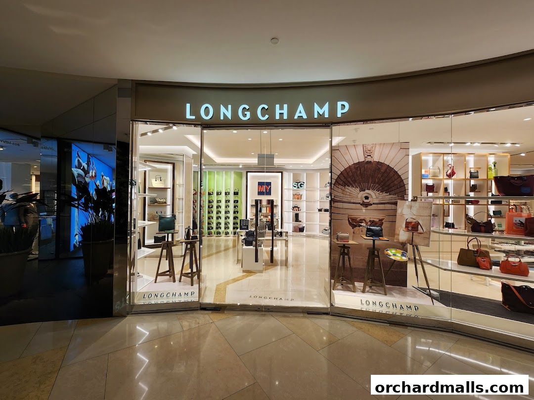 The Longchamp store features a well-lit interior showcasing various handbags and accessories on display.
