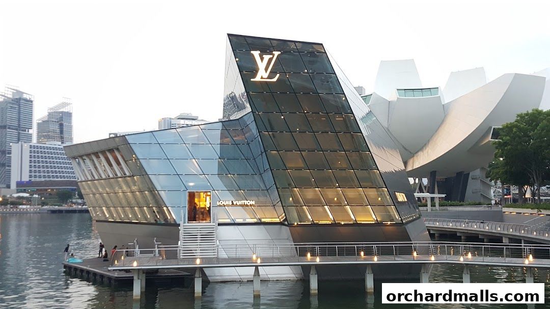 The Louis Vuitton store at Ion Orchard, a modern glass building on the water.