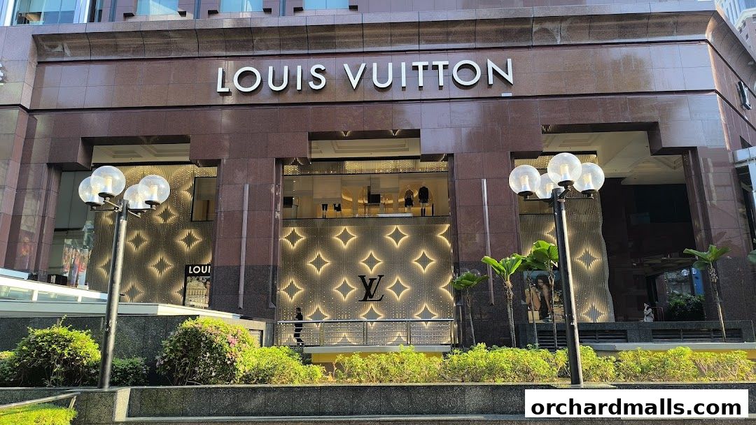 The Louis Vuitton store facade features its iconic logo and illuminated diamond pattern.