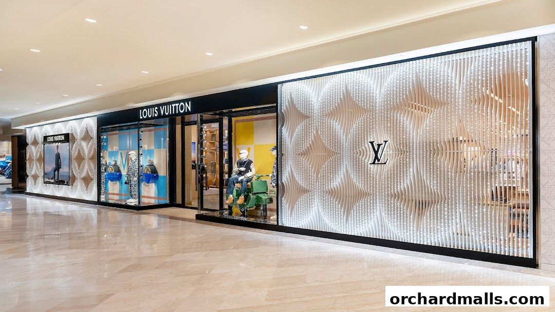 The exterior of a Louis Vuitton store with a modern, illuminated facade and display windows.