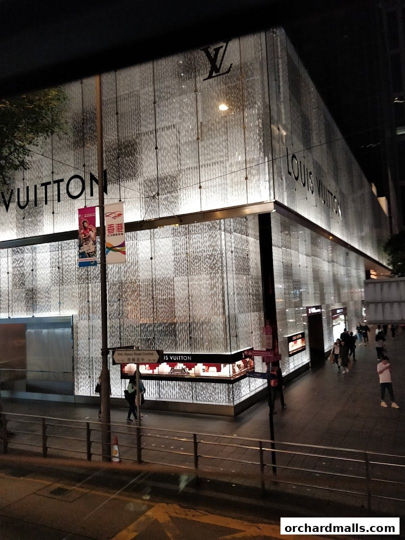 The Louis Vuitton store facade at night, illuminated with a modern, textured glass exterior.
