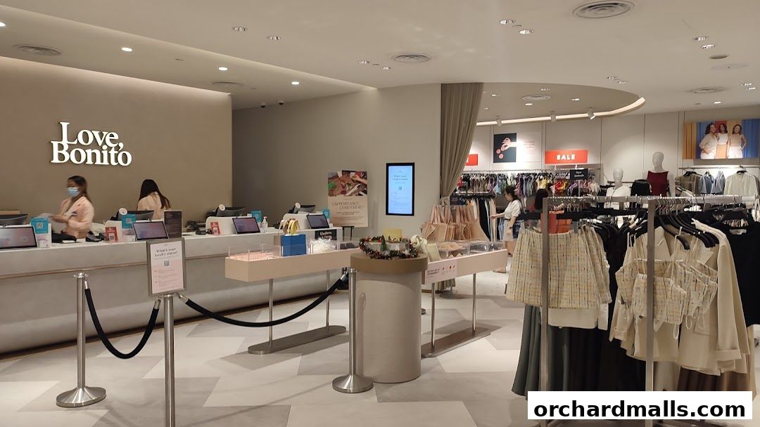 Interior view of a Love, Bonito store with clothing racks and a checkout counter.