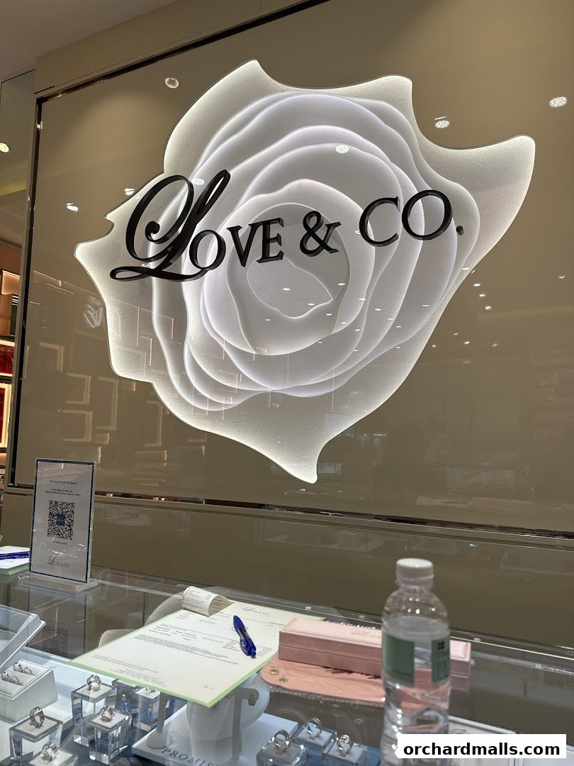 A jewelry store display featuring engagement rings and wedding bands with the store's logo.