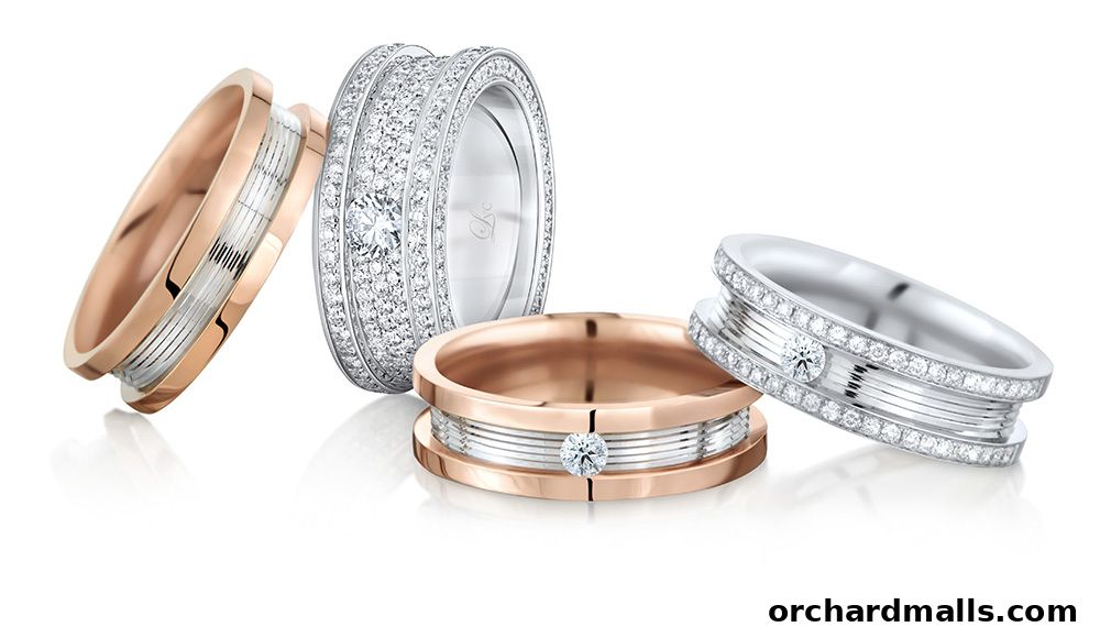 A collection of four diamond-studded wedding and engagement rings in rose gold and white gold.