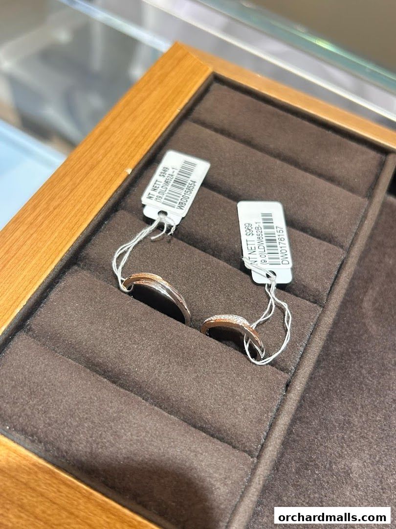 Close-up of two elegant diamond rings displayed in a jewelry store display case.