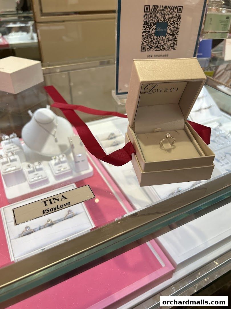 A display case showcasing engagement rings and wedding bands from Love & Co.