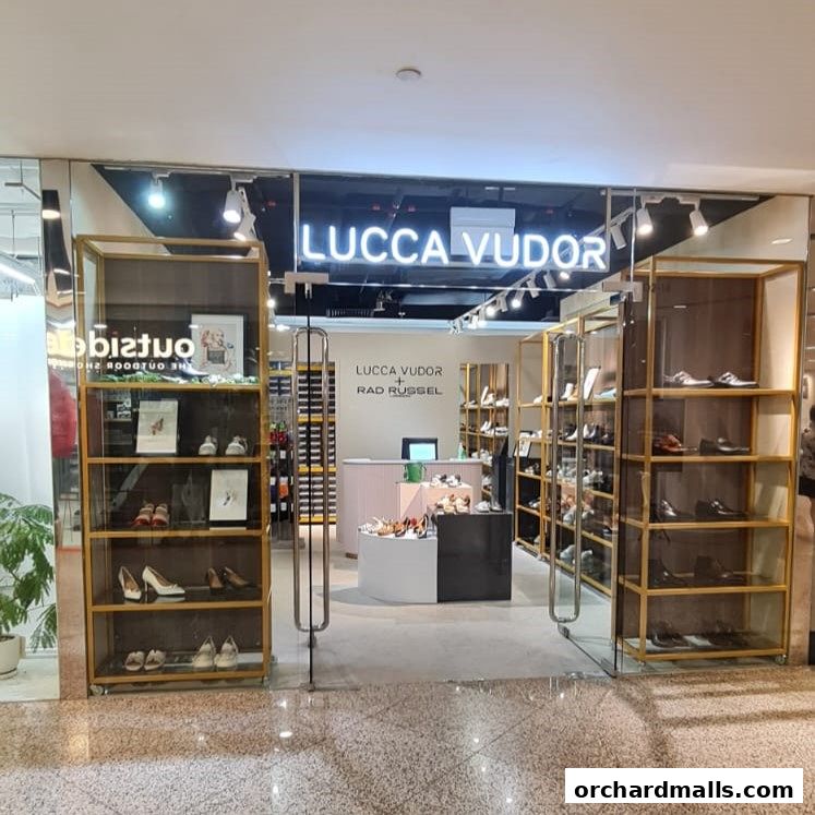 The entrance of Lucca Vudor Rad Russel shoe store, showcasing stylish footwear on display.
