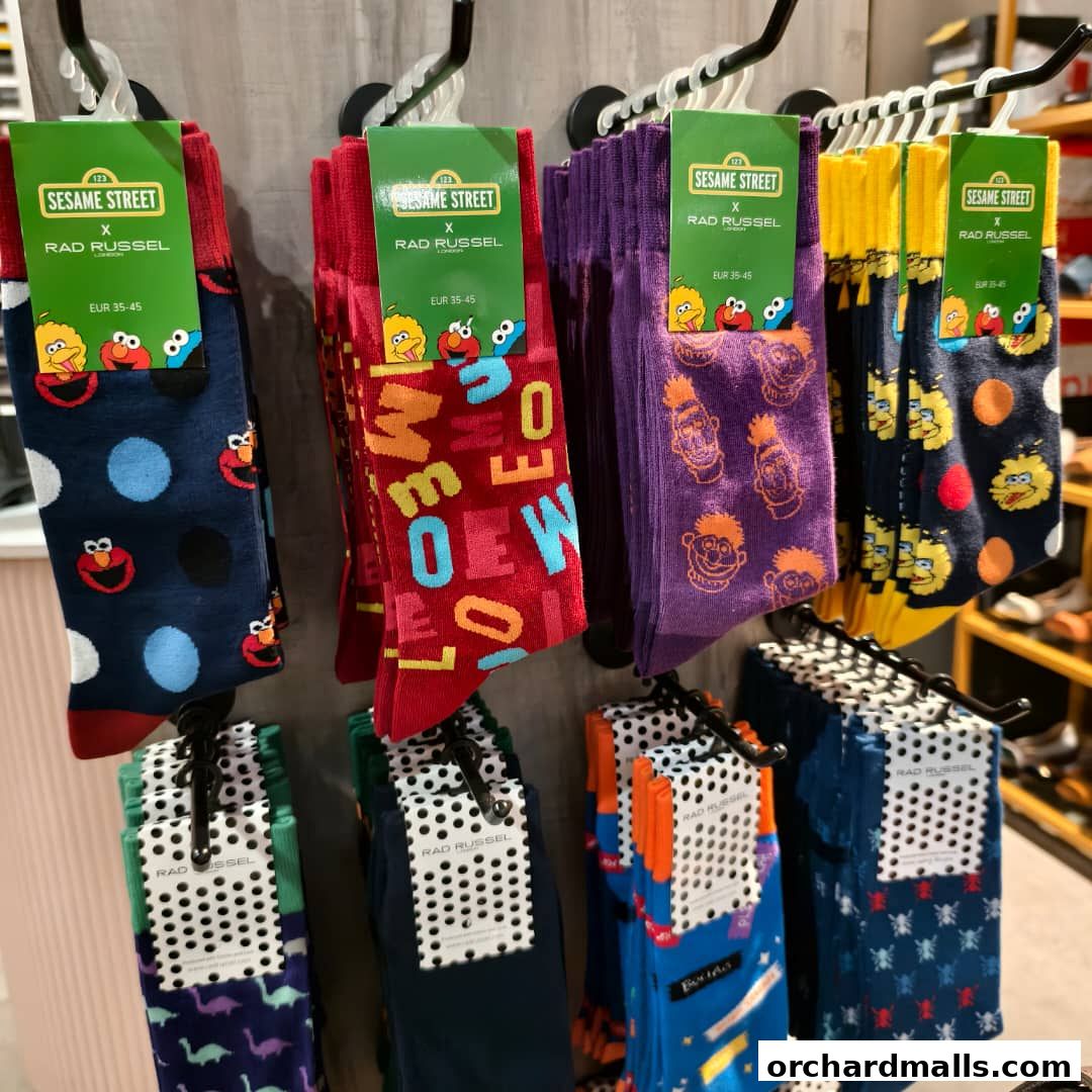 A display of colorful socks featuring Sesame Street characters and designs.