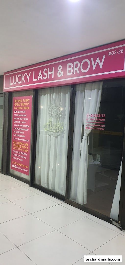 The exterior of Lucky Lash & Brow shop, showcasing services and contact information.