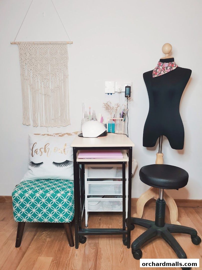 A cozy corner with a chair, desk, and mannequin, set up for lash and brow services.
