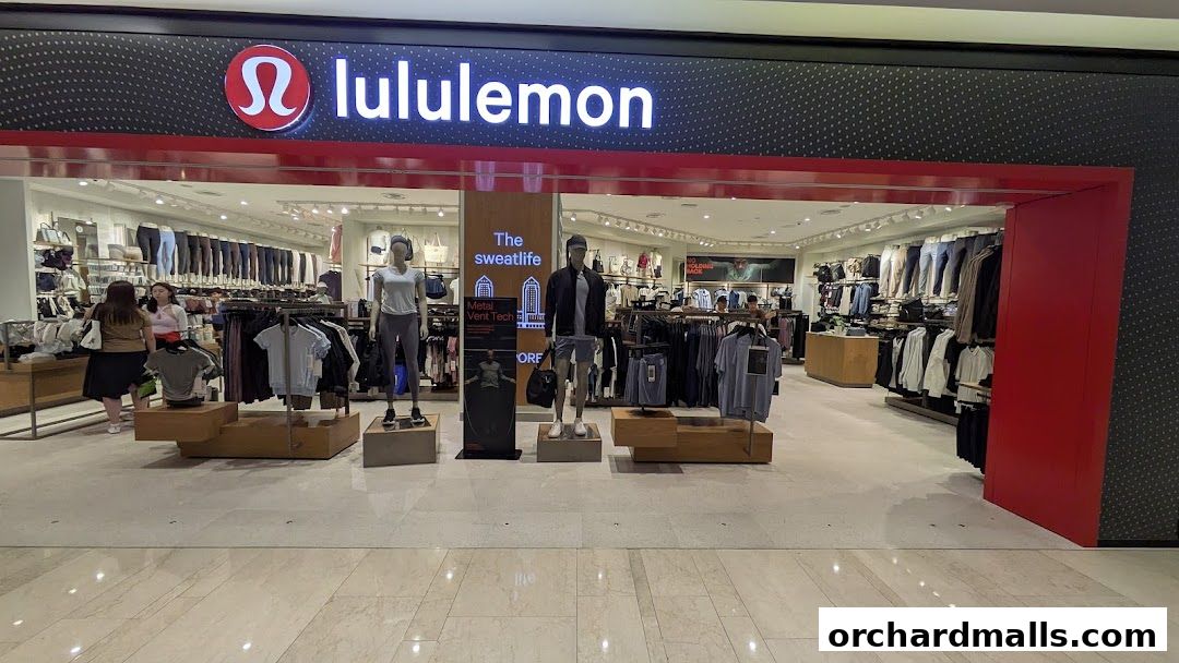 The entrance of a lululemon store displaying athletic apparel on mannequins and racks.