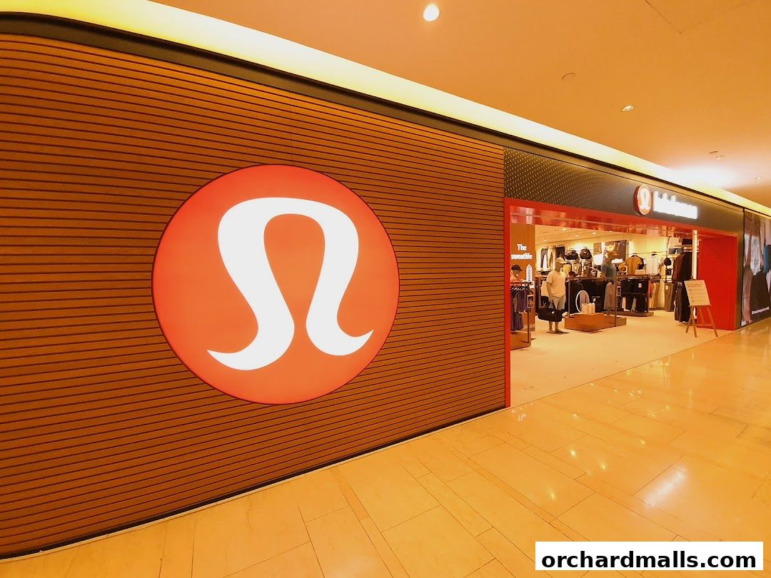The exterior of a Lululemon store with its iconic logo and display of athletic wear.