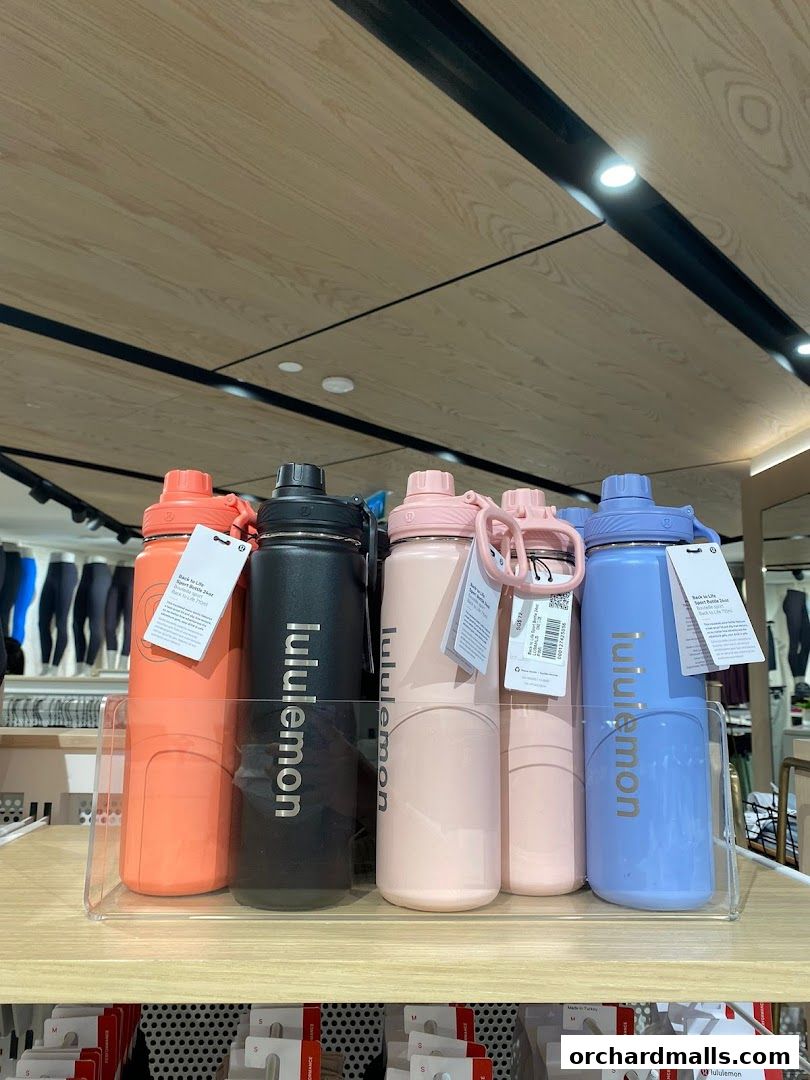 A display of colorful lululemon water bottles in various pastel shades.