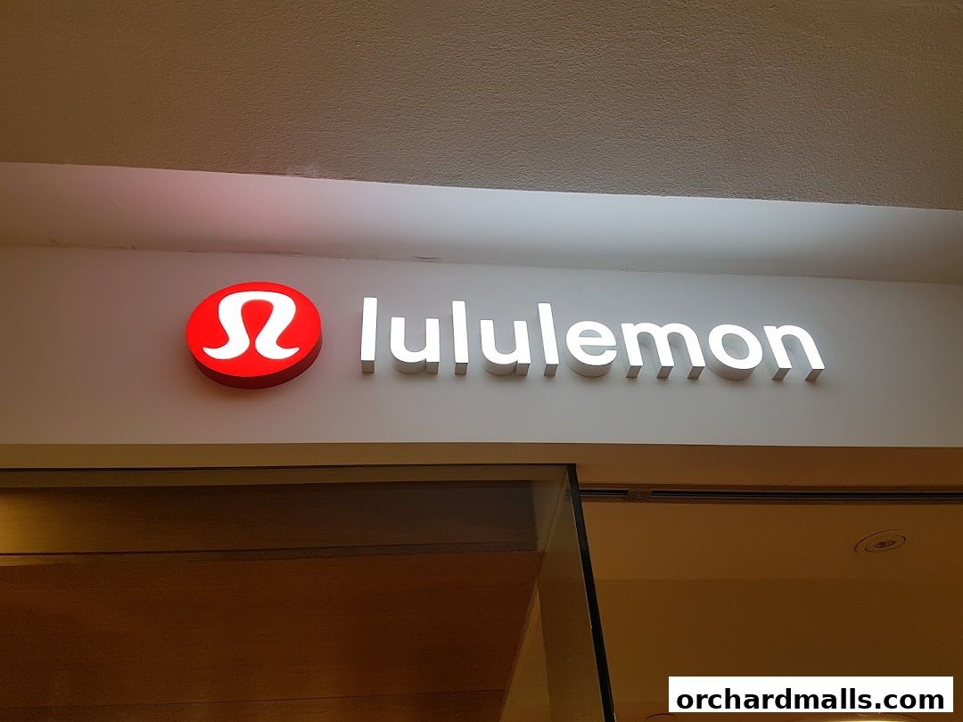 The Lululemon store sign with its iconic red logo and white lettering.