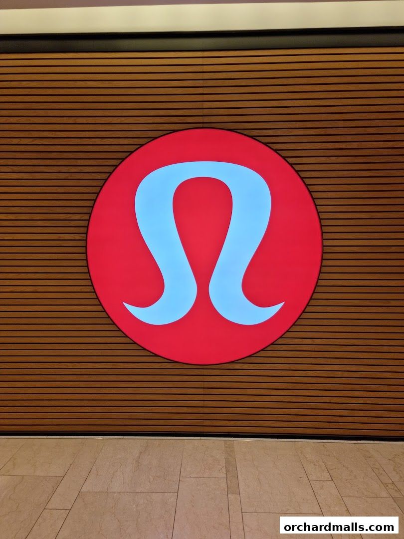 Lululemon logo displayed on a wooden slatted wall.