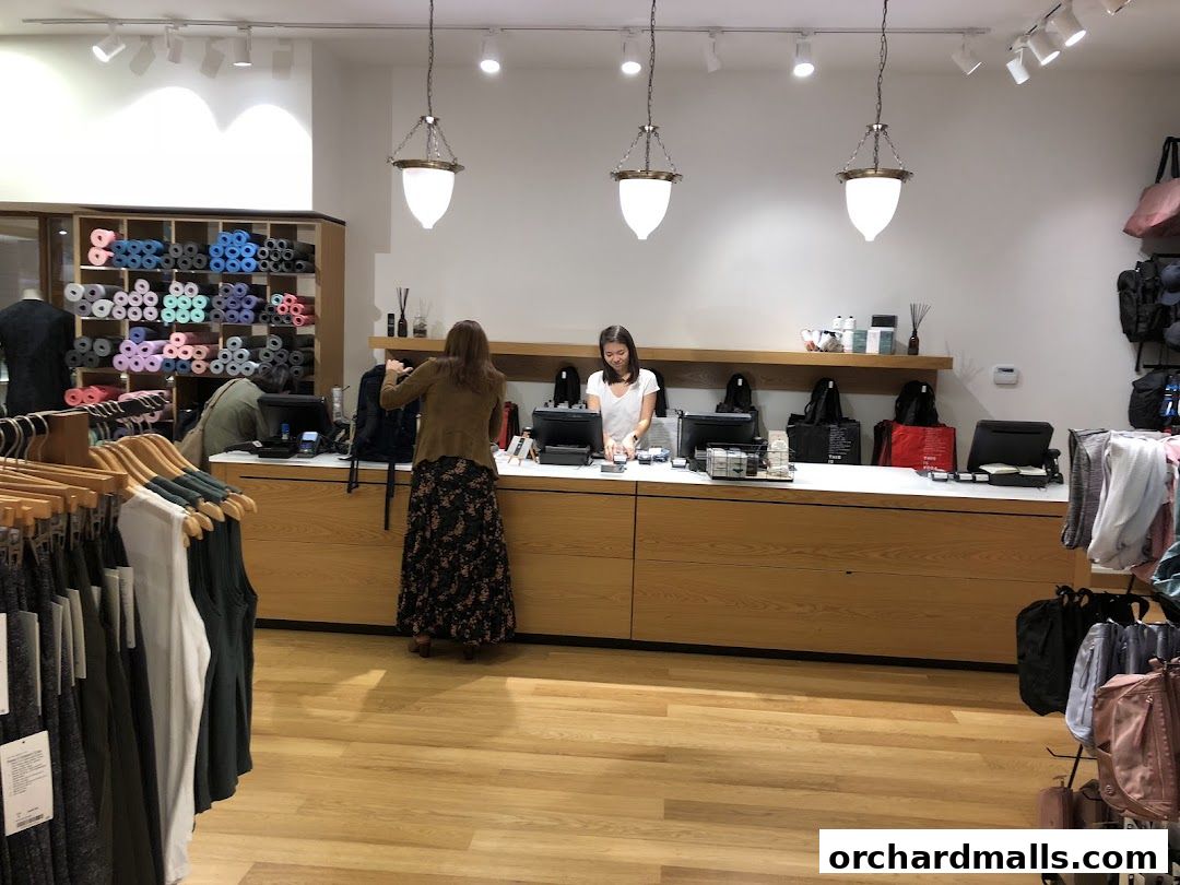 Interior of a Lululemon store with yoga mats, apparel, and a checkout counter.