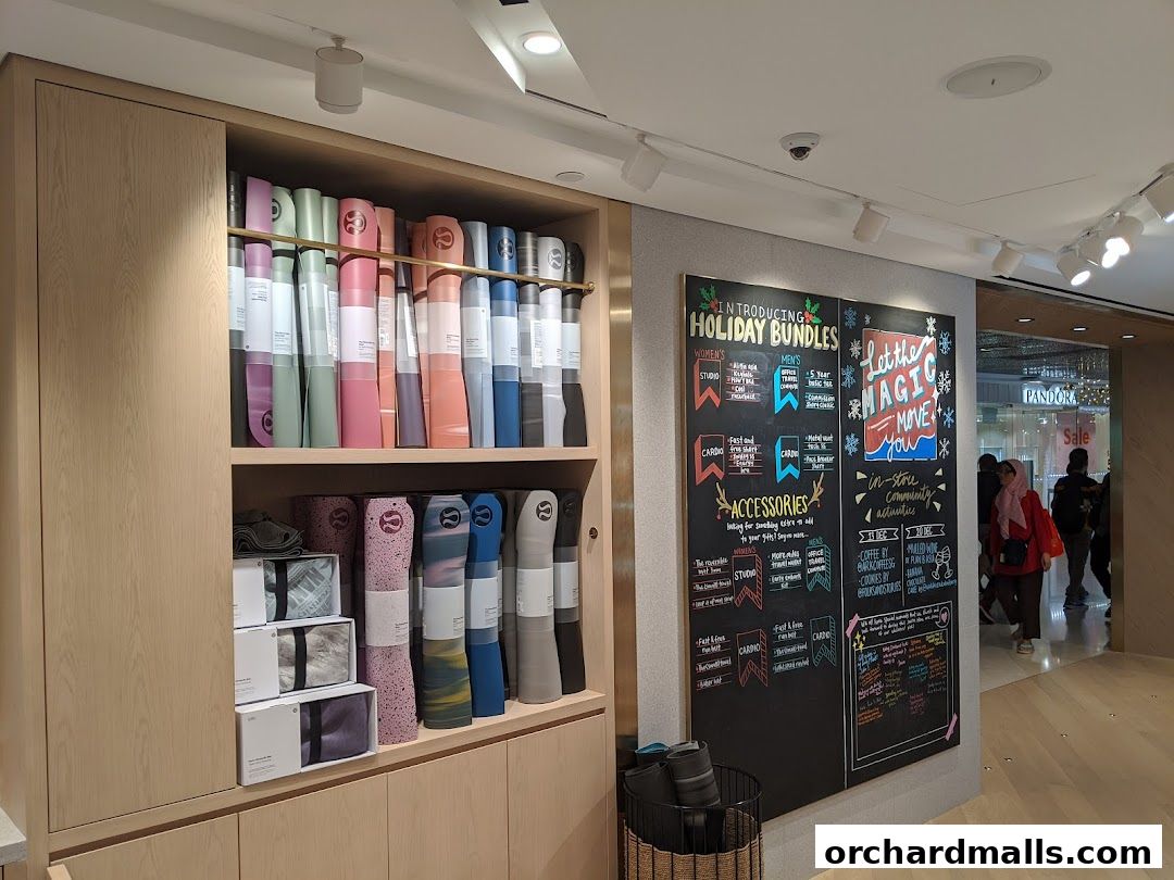 Lululemon store interior with yoga mats and a holiday bundles promotion board.