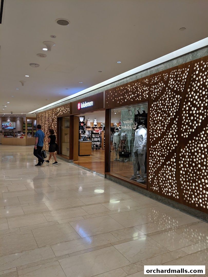 The exterior of a Lululemon store with mannequins displaying athletic wear.
