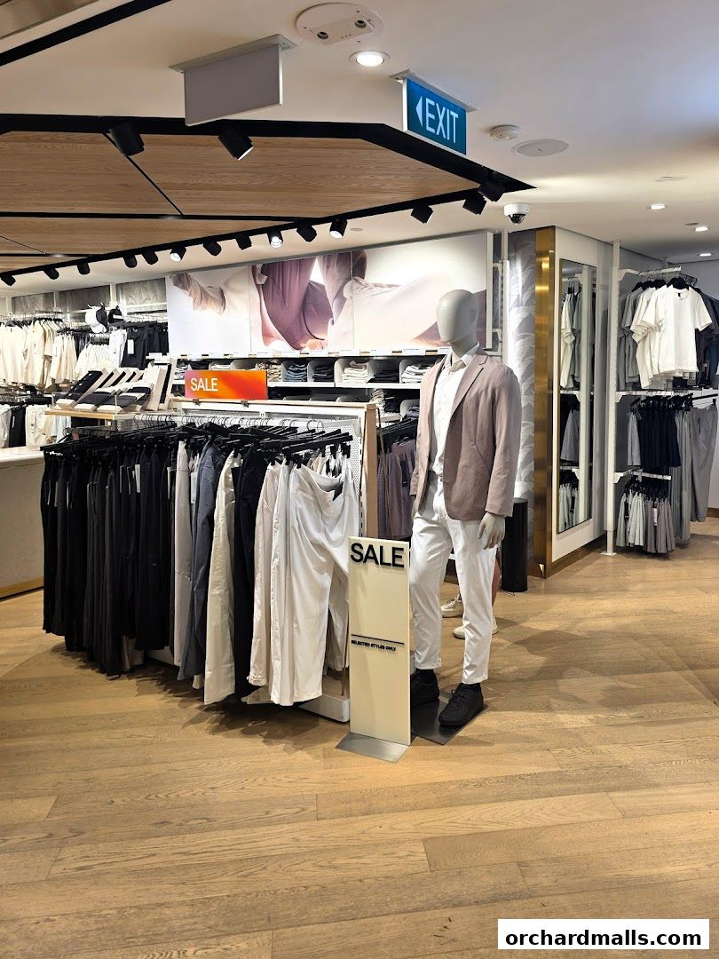 Interior of a lululemon store with clothing racks, a mannequin, and a sale sign.