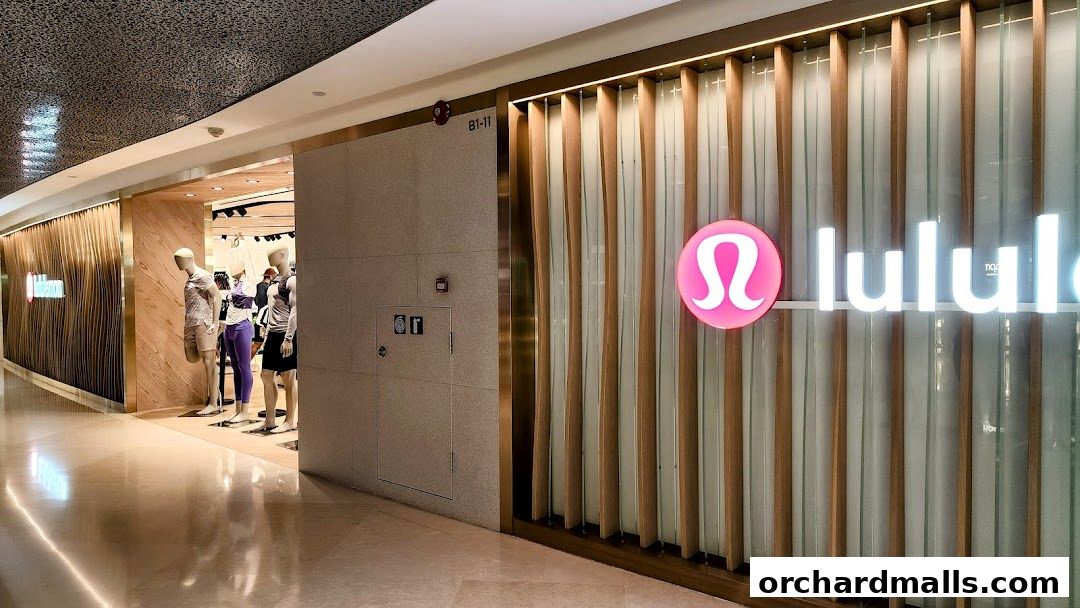 The exterior of a Lululemon store with mannequins displaying athletic wear inside.