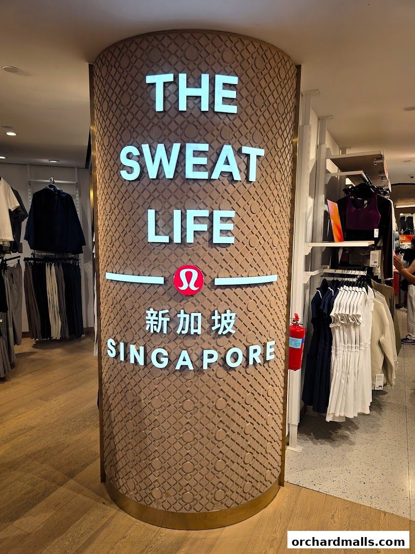 Interior of a Lululemon store with a prominent pillar displaying 'The Sweat Life Singapore'.