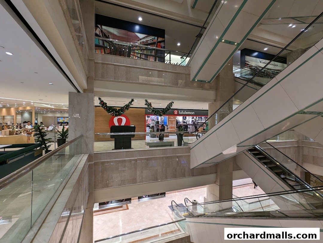 Interior view of a shopping mall with escalators and the lululemon store visible.