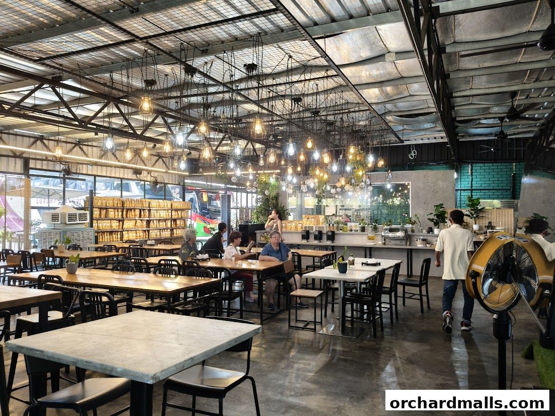 Interior of a spacious restaurant with industrial-style lighting and seating.