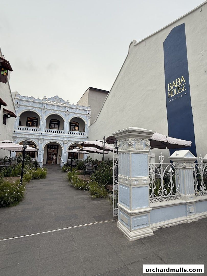 Exterior of Baba House Melaka with outdoor seating and ornate architecture.