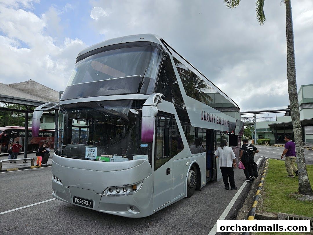 A double-decker bus labeled 'Luxury Exclusive' is parked outside with people boarding.