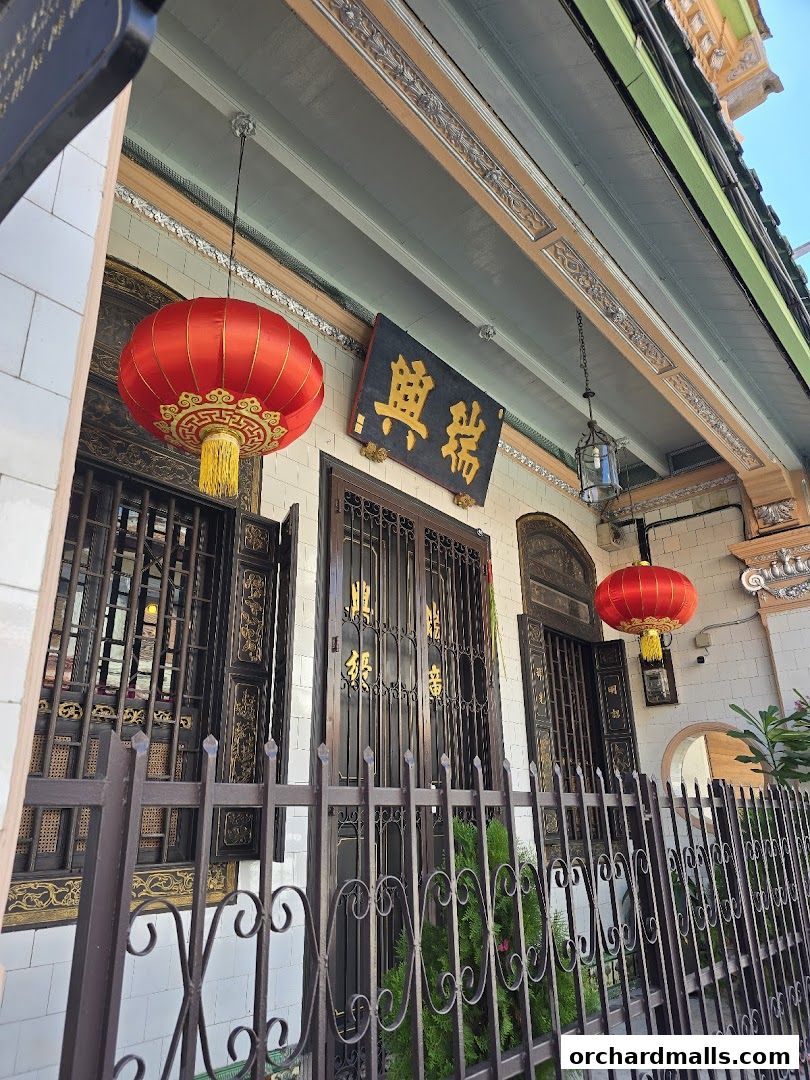 Traditional shop front with ornate details, red lanterns, and intricate metalwork.