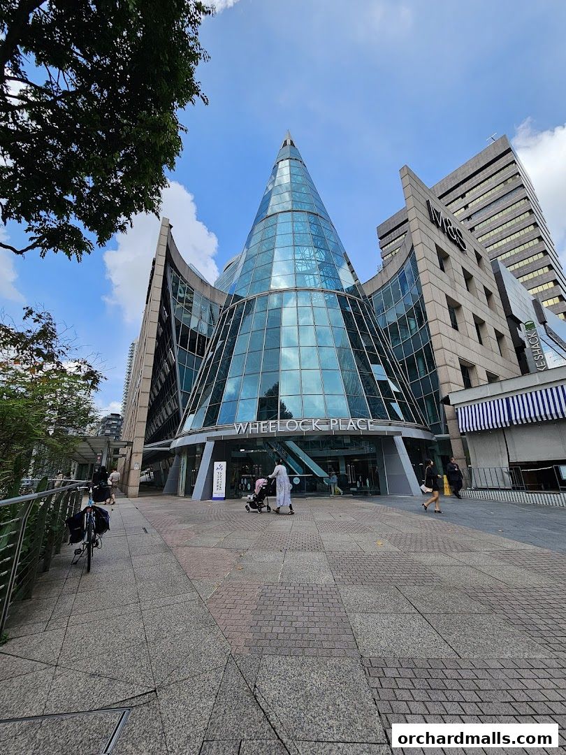 Exterior view of Wheelock Place building with a distinctive glass cone structure.