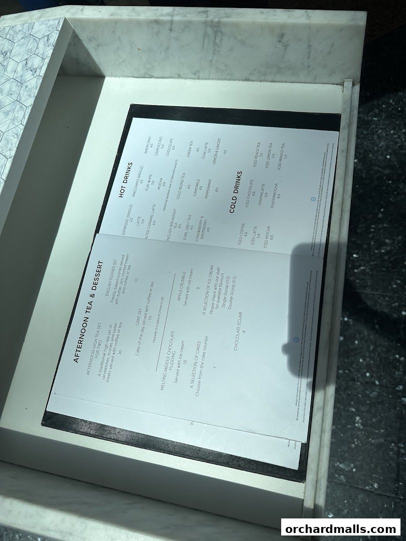 A menu from MS Café displaying hot drinks, cold drinks, afternoon tea, and desserts.