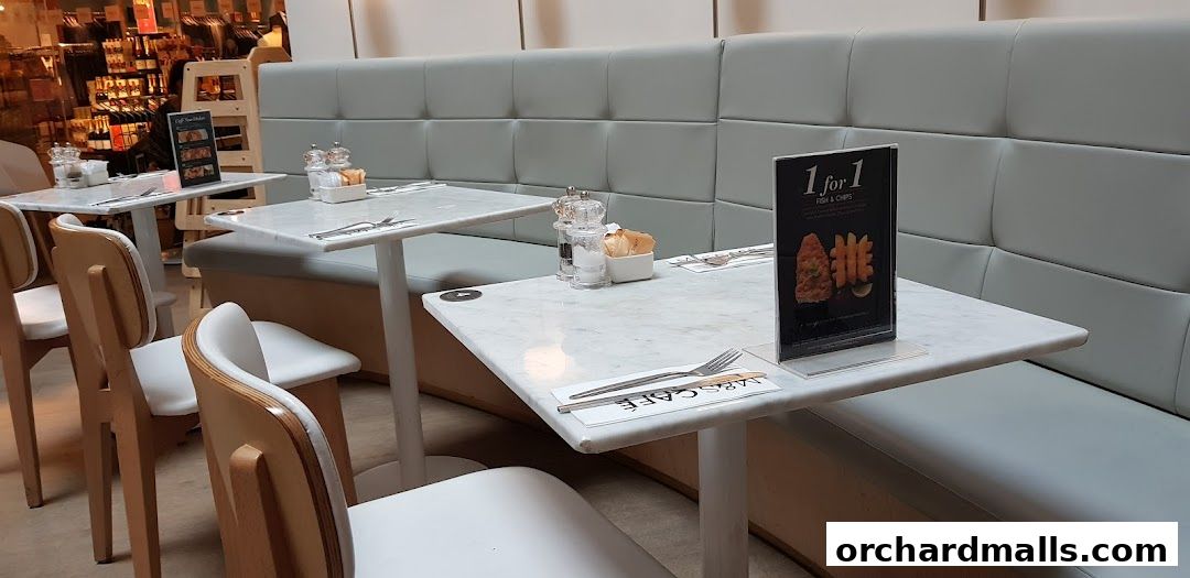 Interior shot of MS Café showing tables, chairs, and a promotional sign.
