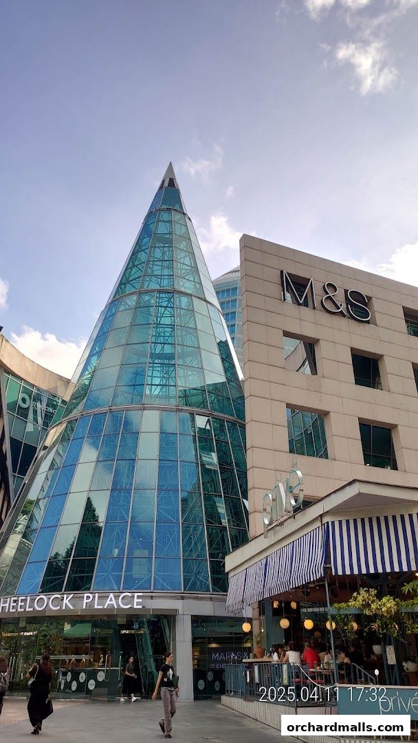 Exterior view of MS Café and Wheelock Place with a modern glass structure.