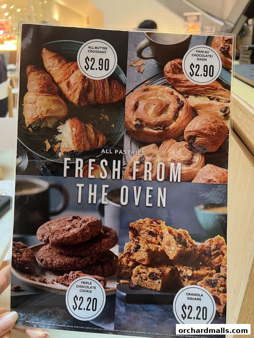 A menu board showcasing pastries and cookies with prices.