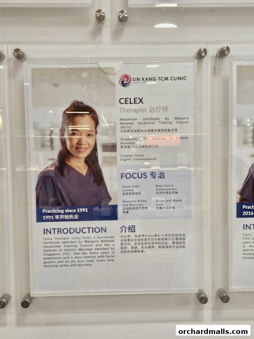 A framed certificate and photo of a therapist at Sin Kang TCM Clinic.
