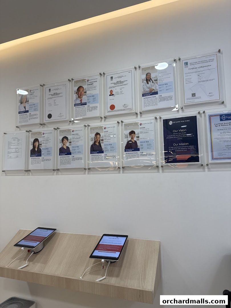 Certificates and tablets displayed on a wall at Ma Kuang Holistic TCM.