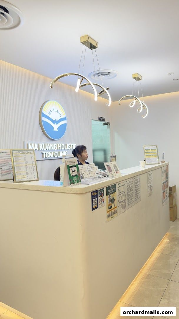 Reception area of Ma Kuang Holistic TCM Clinic with a staff member at the counter.