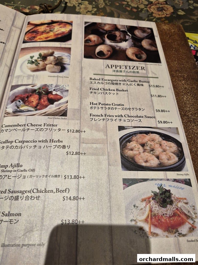 A menu page from Ma Maison featuring appetizers and main dishes with images.