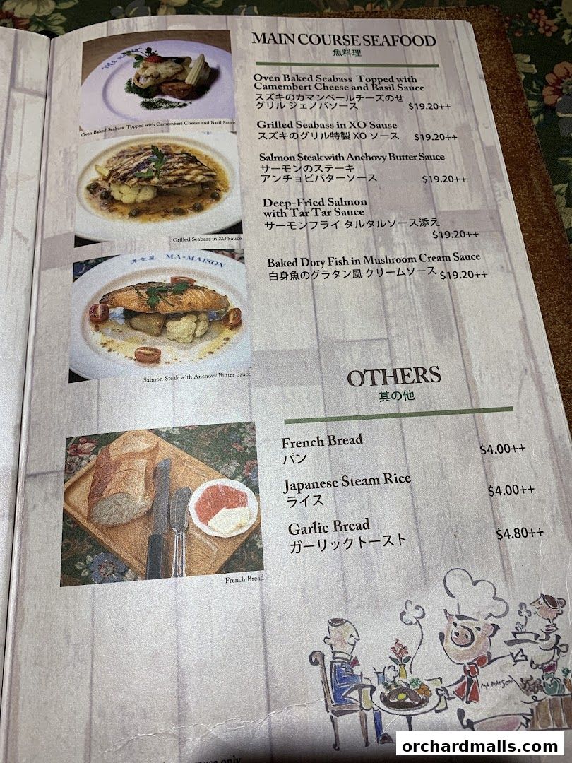 A menu page from Ma Maison featuring seafood main courses and other side dishes.