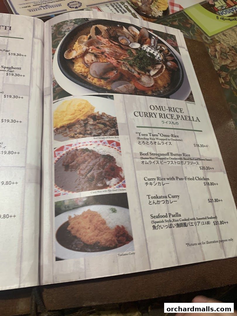 A menu from Ma Maison featuring various rice dishes, curries, and paella.