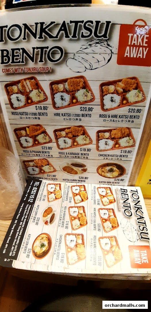 A menu board displaying various Tonkatsu Bento meal options with prices.
