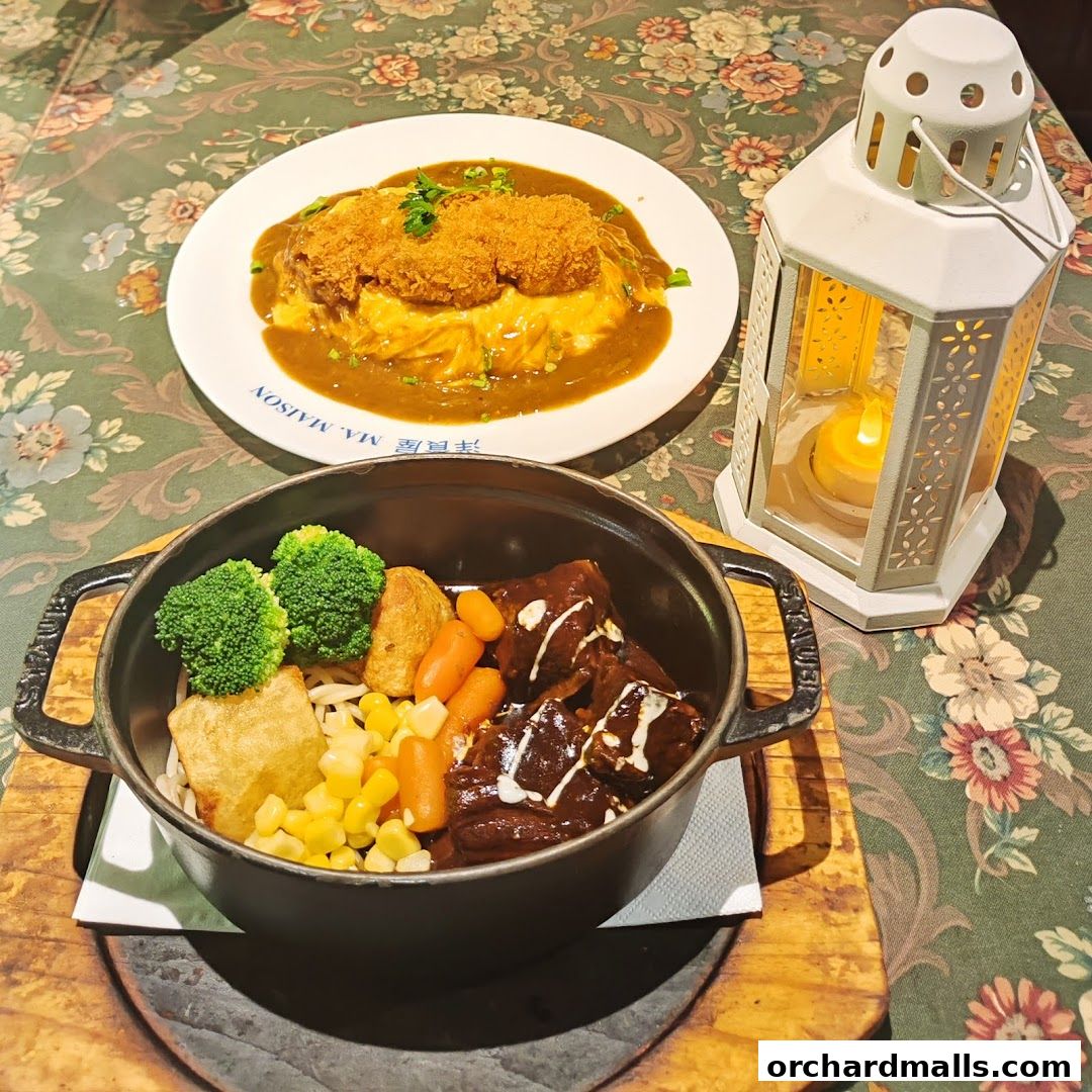 A table setting with two dishes, a lantern, and a floral tablecloth.