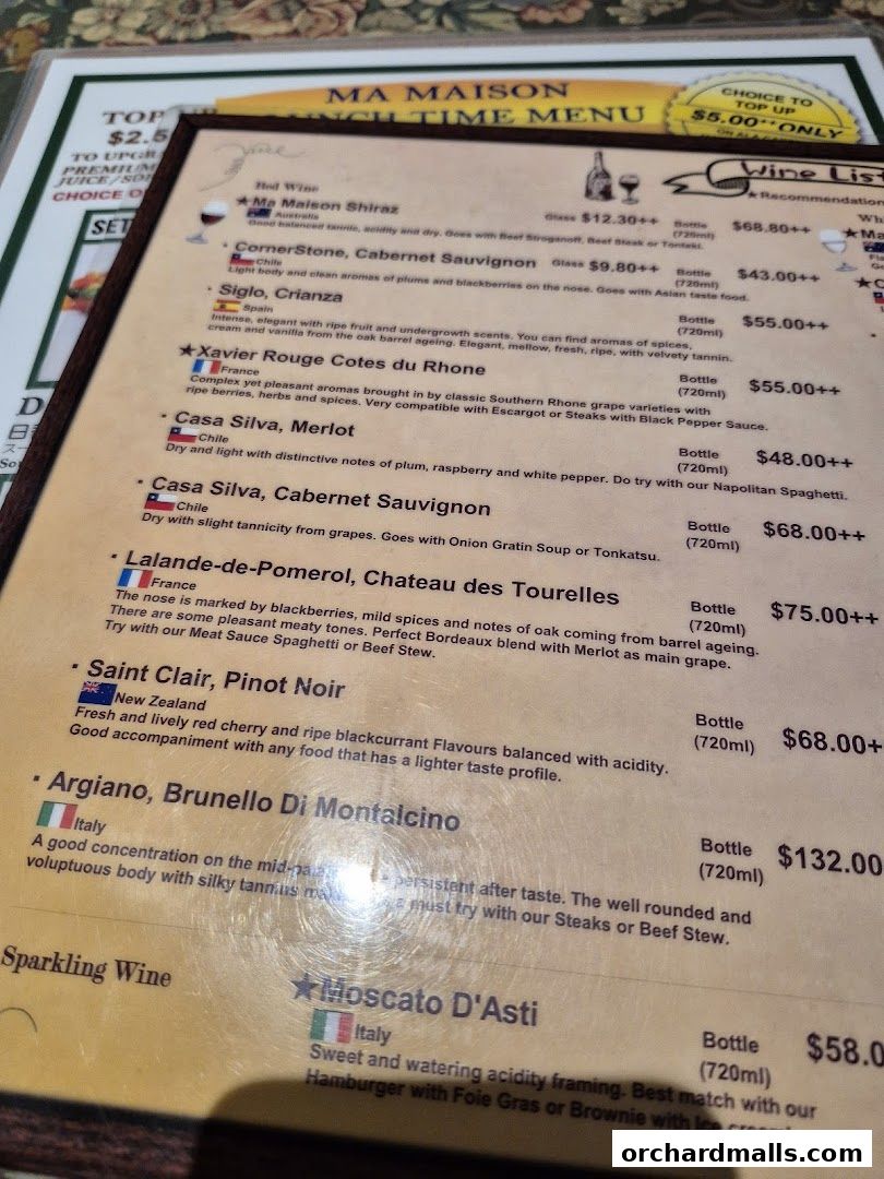 A wine list menu from Ma Maison restaurant with various red and sparkling wines.