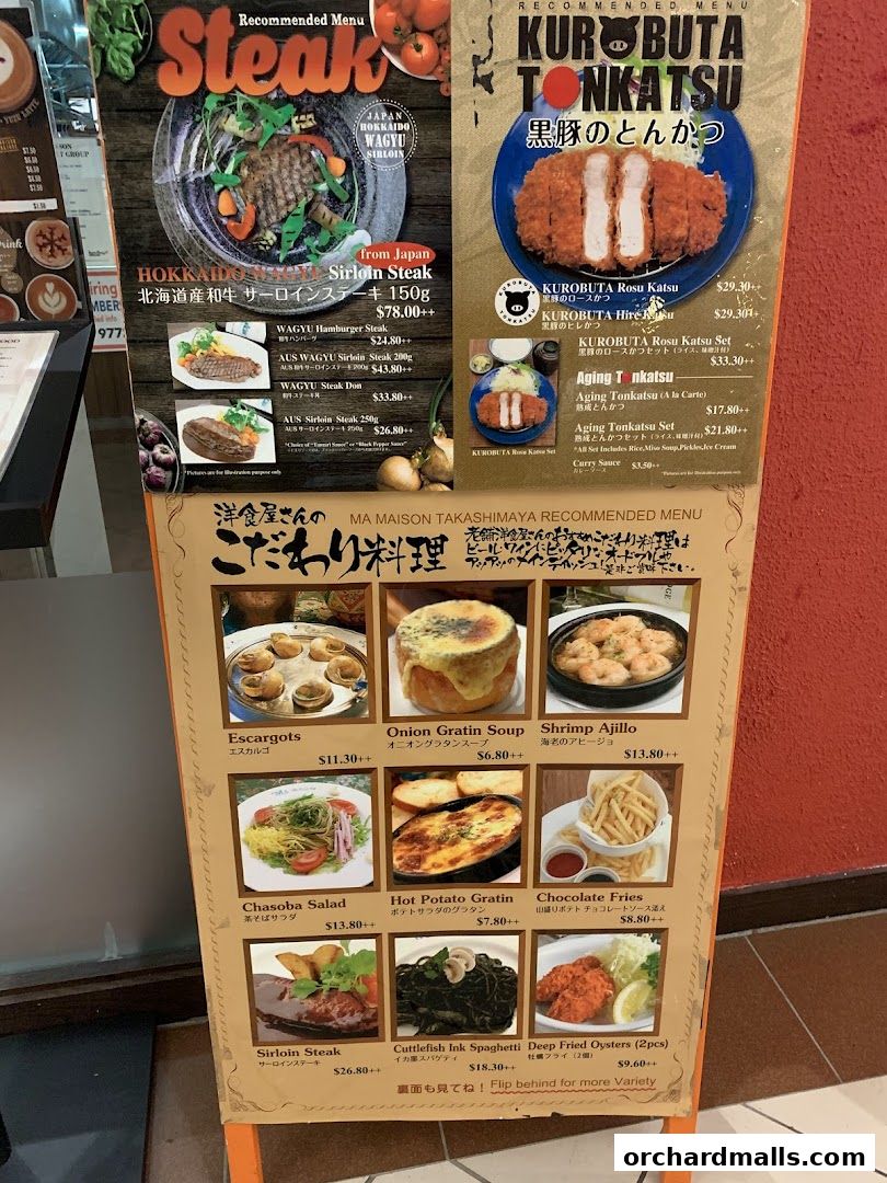 A display board showcasing recommended dishes from Ma Maison, featuring steaks, tonkatsu, and various other meals.