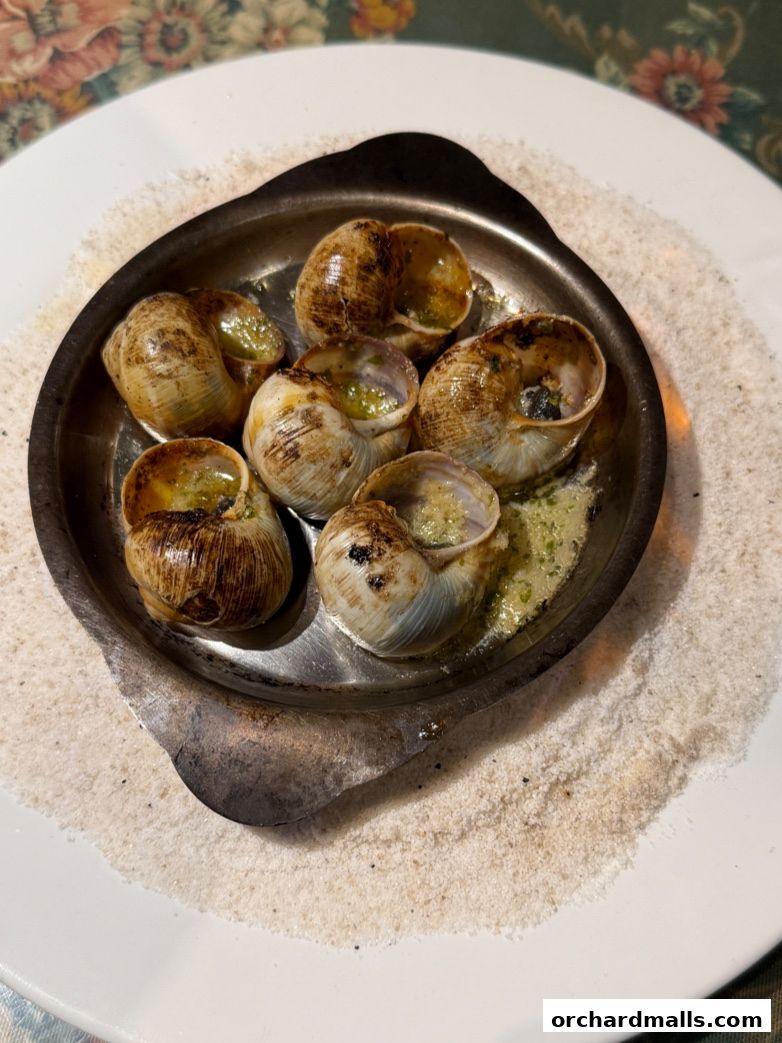 A close-up shot of escargots served in their shells with garlic butter.